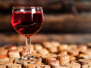 Wine glass on used wine cork background