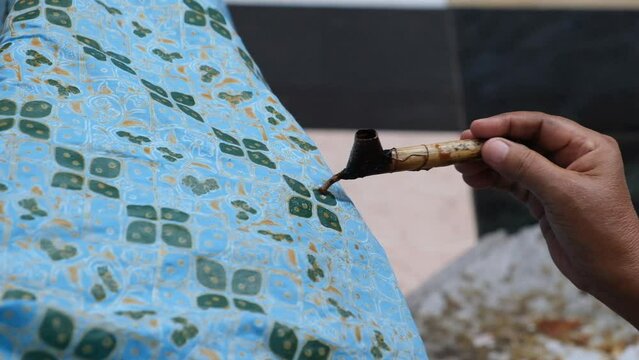 The process of making hand-written batik on a cloth with heated wax, typical of Surakarta in Indonesia
