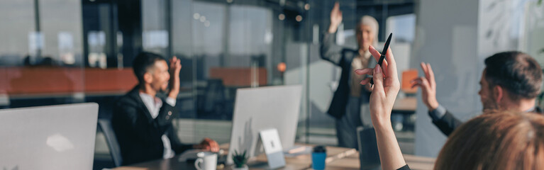 Busy multiethnic coworkers cooperating and working together at office meeting, teamwork concept