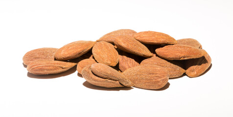 Shelled almonds (Prunus dulcis). A lot of peeled almonds on a white field.