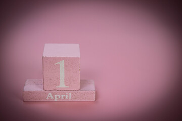 Pink wooden letters  shows the date April 1 ,april fool day , isolated on pink background with copy space