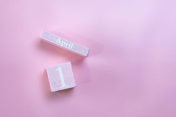Pink wooden letters  shows the date April 1 ,april fool day , isolated on pink background with copy space