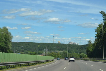 Strong barrier type fencing on a high-speed road against the backdrop of the perspective of the road under the blue sky