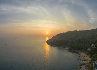 aerial view the sun going down in colorful sky impact on ocean surface.The beauty of the cliff fits perfectly with the charming nature in beautiful sunset..cloud scape background