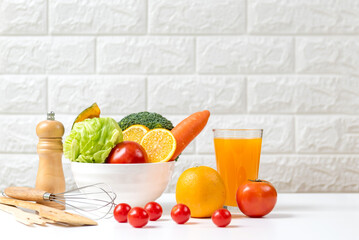 Diet and healthy fresh vegetable fruits for detox body slim fit for health lifestyle with Sport exercise equipment workout and orange juice,  white background. Weight Loss and Diet Concept