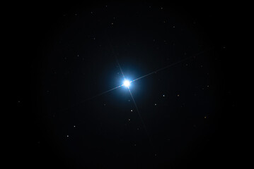Obraz na płótnie Canvas Night sky background with bright Sirius star on black sky with stars. Astro photo on winter night with soft selective focus
