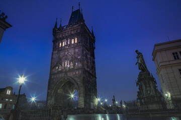 Naklejka premium Charles Bridge, Prague at dramatic evening, Czech Republic, with night lighting
