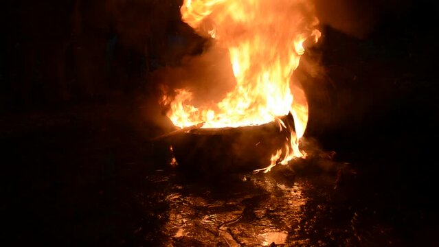 burning wheel closeup in the night, danger fire flame, stress euromaidan diversity