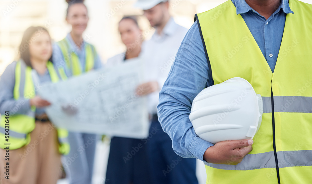 Poster helmet, construction and an architect standing on a building site with his team planning in the back