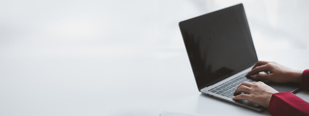 Person typing on laptop keyboard, businessman working on laptop, he is typing messages to...