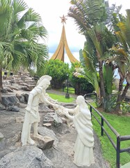 Two statues representing the guard taking the baby from the mother in the nativity scene located in the lookout next to the New Basilica of Aparecida.