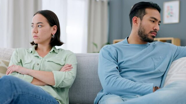 Fight, divorce and angry couple on a sofa in living room at home with husband hurt after erectile dysfunction argument. Marriage, infertility and upset man on the couch with his frustrated young wife