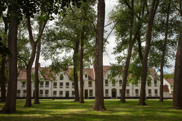 Naklejka premium Flemish and ornate architecture of idyllic Bruges with garden park, Flanders, Belgium