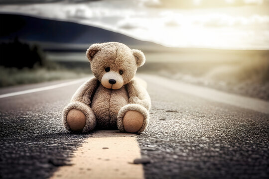 toy bear on an asphalt road. abandoned toy. sad mood in a dark key