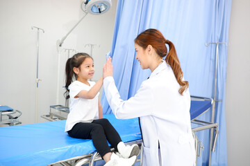 female doctor cheering up sick girl.
