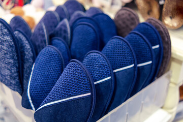Warm blue slippers stand in a row