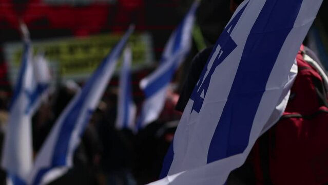 A protester with the Israeli flag, a protester against the government, a demonstration in Jerusalem near the Israeli Knesset