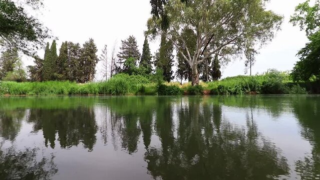 The Jordan River near Kfar Blum in the north of Israel, a calm turquoise stream