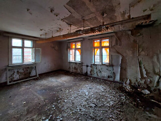 Fototapeta na wymiar Desolate room in a ruined house, lost place