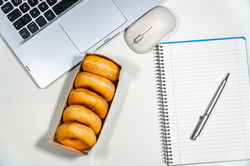 Top view, donuts on a desk with laptot