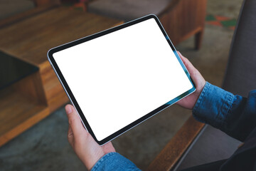 Mockup image of a woman holding digital tablet with blank white desktop screen