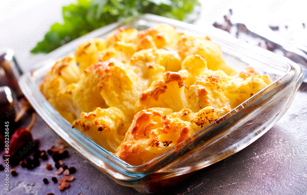 Wall mural Savory food: baked cauliflower with cheese, eggs and cream close-up in a baking dish on a table.