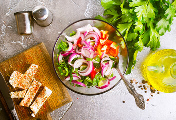 greek salad in bowl, salad with vegetables and cheese on board