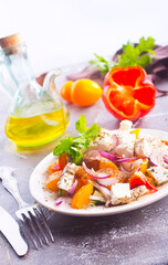 Greek salad of fresh cucumber, tomato, sweet pepper, lettuce, red onion, feta cheese and olives with olive oil. Healthy food, top view