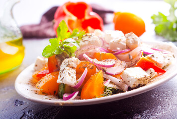 Greek salad of fresh cucumber, tomato, sweet pepper, lettuce, red onion, feta cheese and olives with olive oil. Healthy food, top view