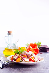 Greek salad of fresh cucumber, tomato, sweet pepper, lettuce, red onion, feta cheese and olives with olive oil. Healthy food, top view