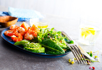 Buddha bowl with soft boiled egg, avocado, greens, grilled shrimps and sauce. Lunch bowl.