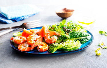 Buddha bowl with soft boiled egg, avocado, greens, grilled shrimps and sauce. Lunch bowl.