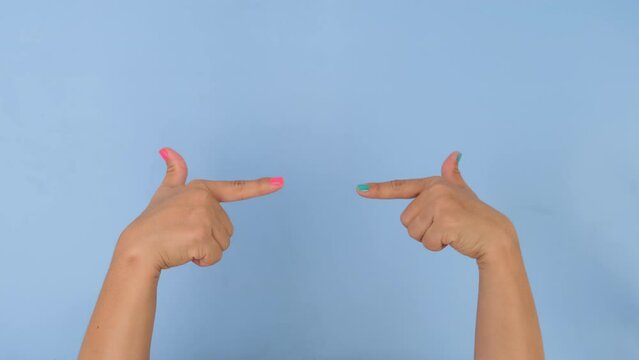 Female hands clapping and pointing with index finger on pastel blue background in studio. Pack of Gestures movements and body language.