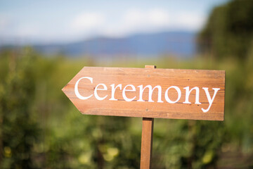 Close-up of ceremony text on sign board at field