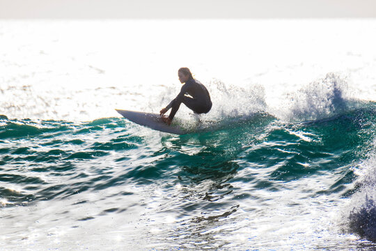 Carefree teenage boy surfing in sea