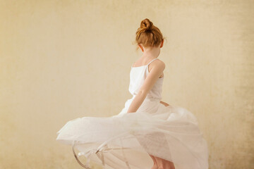 Girl dancing against wall