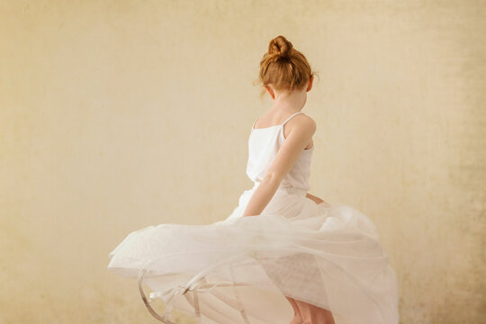 Girl dancing against wall
