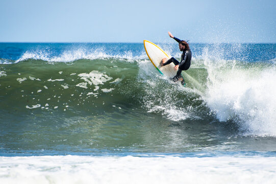 Carefree man surfing on sea against clear sky