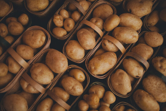 Close-up of fresh potatoes in baskets for sale at market