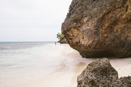 Mid distance view of woman on shore against sky at beach