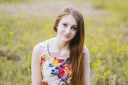 Portrait of confident young woman on field
