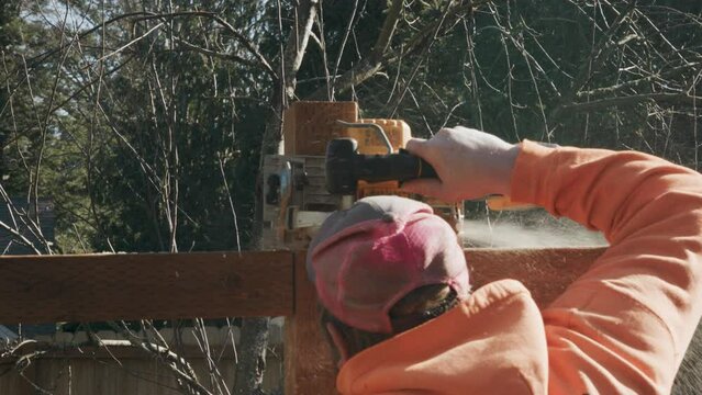 Sawing the Top off Fence Post Bearded Construction Guy Building