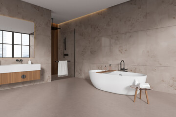 Beige bathroom interior with sink, douche and bathtub with accessories