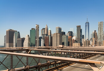 Fototapeta na wymiar Brooklyn bridge and New York business centre, skyscrapers under blue sky