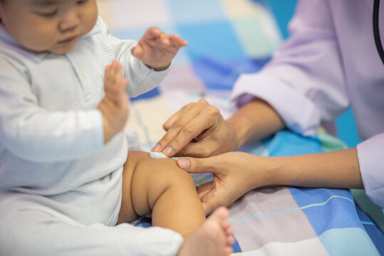 pediatrician Hand hold vaccine liquid injection in syringe for injecting child baby infant. small syringe needle for infant prevention flu by vaccination immunity in Pediatrics hospital clinic.