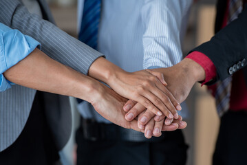 business teamwork putting join hands together. Unity and teamwork show by Stack mix of hands with...