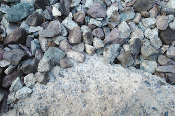 Piles of stones and rock various sizes and shape on the ground