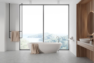 Fototapeta na wymiar Light bathroom interior with sink and mirror, tub near panoramic window