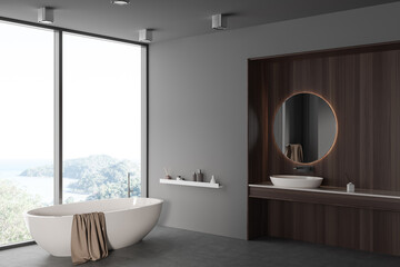 Fototapeta na wymiar Grey bathroom interior with sink and mirror, tub near panoramic window. Mockup