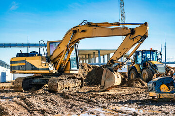 Yellow crawler excavator at the construction site. Earthworks at a construction site. Modern...